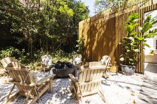 <span style="font-family: Theinhardt, -apple-system, BlinkMacSystemFont, &quot;Segoe UI&quot;, Roboto, Oxygen-Sans, Ubuntu, Cantarell, &quot;Helvetica Neue&quot;, sans-serif;">Wood adirondack chairs surrounding a stone firepit. </span>