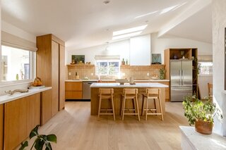 Light pours into the renovated kitchen from all directions, with the breezy natural palette transforming the room into a warm and inviting family space. After removing walls, the dated and mismatched floors became an eyesore, with Leah opting to replace them with Hakwood Engineered European Oak floors in ‘Aura,’ which run throughout the home.