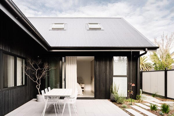 Natalie and Lauren wanted to replicate the feel of a Zen garden with their home’s central courtyard. The garden features a Japanese maple that pops against the charred timber cladding, while structurally, the U-shape design ushers light right through to the back of the house.