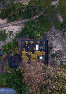 Stanaćev and Granados not only thought about views from the cabin, they also considered views of the cabin. With that in mind, they designed a green roof planted with creeping redflush that harmonizes with surrounding cypress forest.