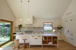 This home that was built atop of home constructed in World War I is completely reimagined by Daniel Rabin and Annie Ritz of local architecture and design firm And And And Studio. Details like fluted white cabinetry in the kitchen give this LA home a posh look.