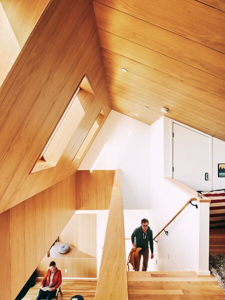 A second story loft offers a cozy place to lounge and watch movies. The stairwell wall is the "guest book