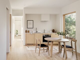 A small kitchenette comes complete with a cook top and oven. White oak wood flooring is used throughout, as a standard feature.