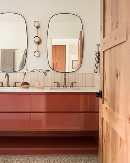 A terracotta vanity expands across the full length of the bathroom.