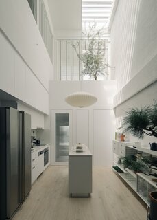 After: An all-white palette at the kitchen and master bathroom above creates a cohesive and calm atmosphere. 