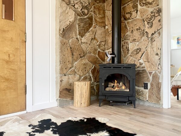 After - living room (Rubio monocoat floors, Chantilly lace walls, used fireplace)