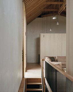 An English Sycamore partition wall allows light to spread into the shower room tucked behind it.