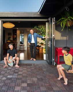 Francis and RJ relax at home with their two young children.