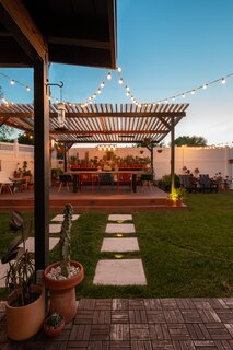 In the backyard, the couple added a pergola, greenhouse, and outdoor dining space for $6,000.