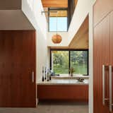 The custom breakfast nook brings natural light in from above and frames the surrounding landscape, allowing the family to appreciate the play of morning light over the meadow.&nbsp;