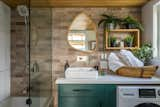 The bathroom in the Nysos comes with stainless-steel fixtures and a five-foot tub. Similar homes by the builder feature an enclosed shower or a freestanding bathtub. Others place the combined washer and dryer in the kitchen. The brick veneer can be swapped with wood or tile.