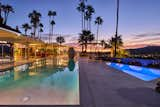 In the backyard, a sprawling concrete patio with a pool and spa overlooks the Coachella Valley.