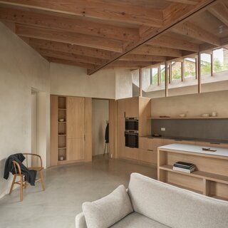 Polished concrete floors and pale clay plaster on the walls were used throughout the kitchen and living spaces.