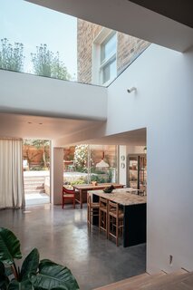 Skylights allow for sun to reach the inside of the home, while providing views of the sky and wildflower roof.