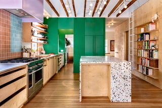 The countertop is a custom Concrete Collaborative terrazzo, and the colored flecks nod to the wall tiles. 