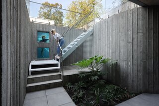 The courtyard brings natural light into the lower level of the home, which has a den/media room, guest suite/workout area, and storage and mechanical.