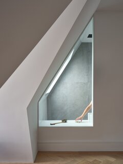 The ensuite is an oasis, featuring a steam shower and peekaboo windows. Stoncrete tiles are from Ciot.