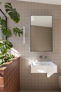 The tile looks vintage, but was selected and installed as part of the renovation. On the vanity: Kristall Tumbler in Blush by Decor Walther from the Oliver Thom Store.