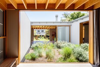 The U-shaped floorplan wraps around a sunny central courtyard.